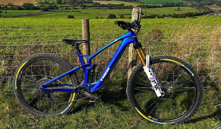 trek fuel blue e-bike on a mountain